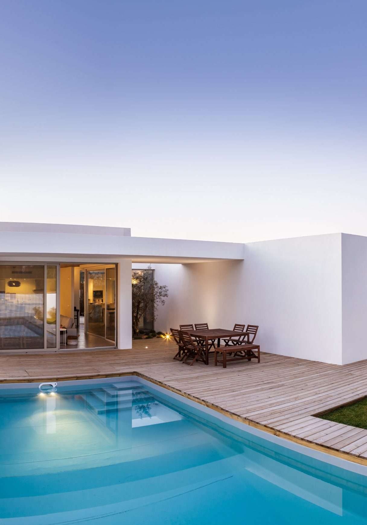Modern house with garden swimming pool and wooden deck