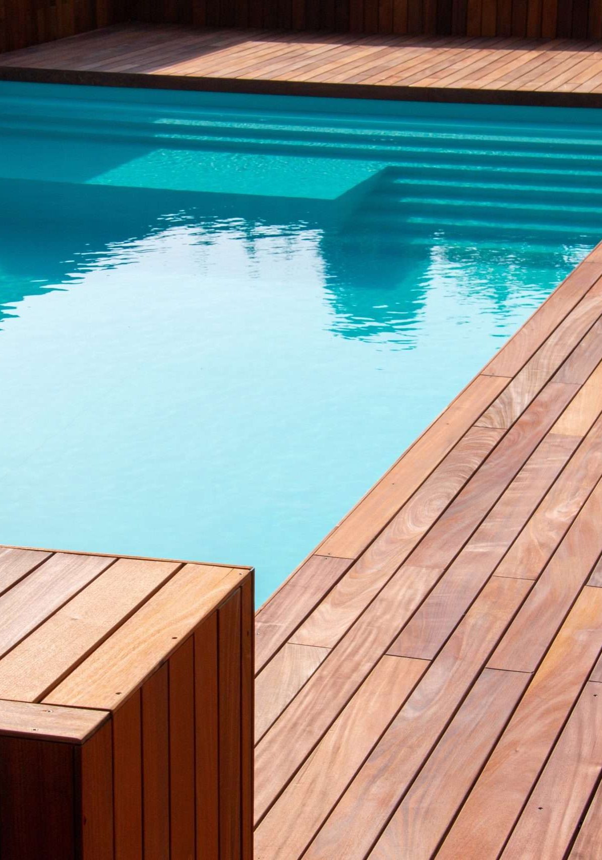 Hardwood ipe pool deck on direct sun heat, summer swimming pool
